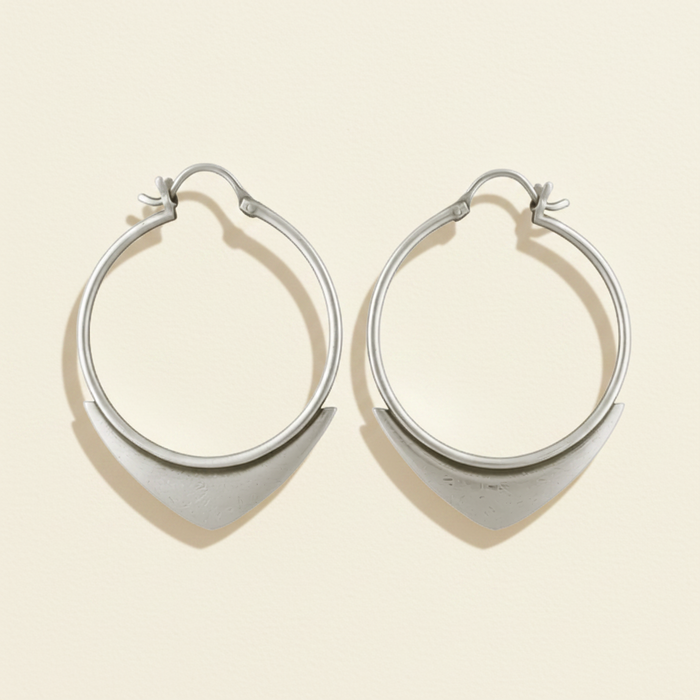 Silver wire hoop earrings with small spearhead-style charm at the bottom